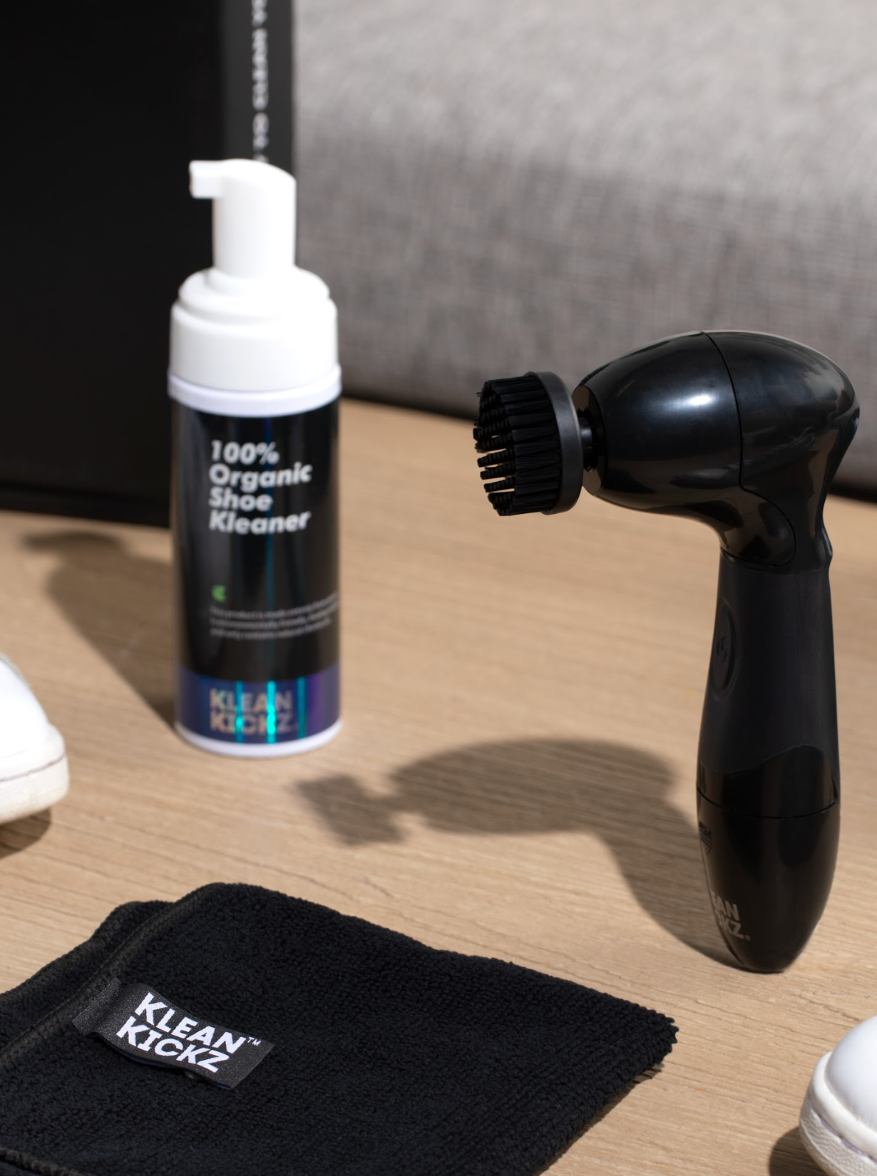 Scrub Brush standing upright next to the Organic Shoe Cleaner & Klean Kickz towel
